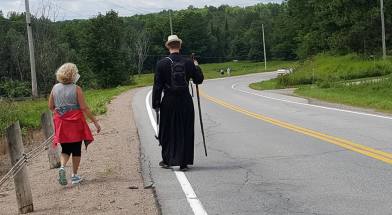 Fr. Scott and Sue Dagenais walk along Hwy. 32, a section of what was formerly the Opeongo Line.